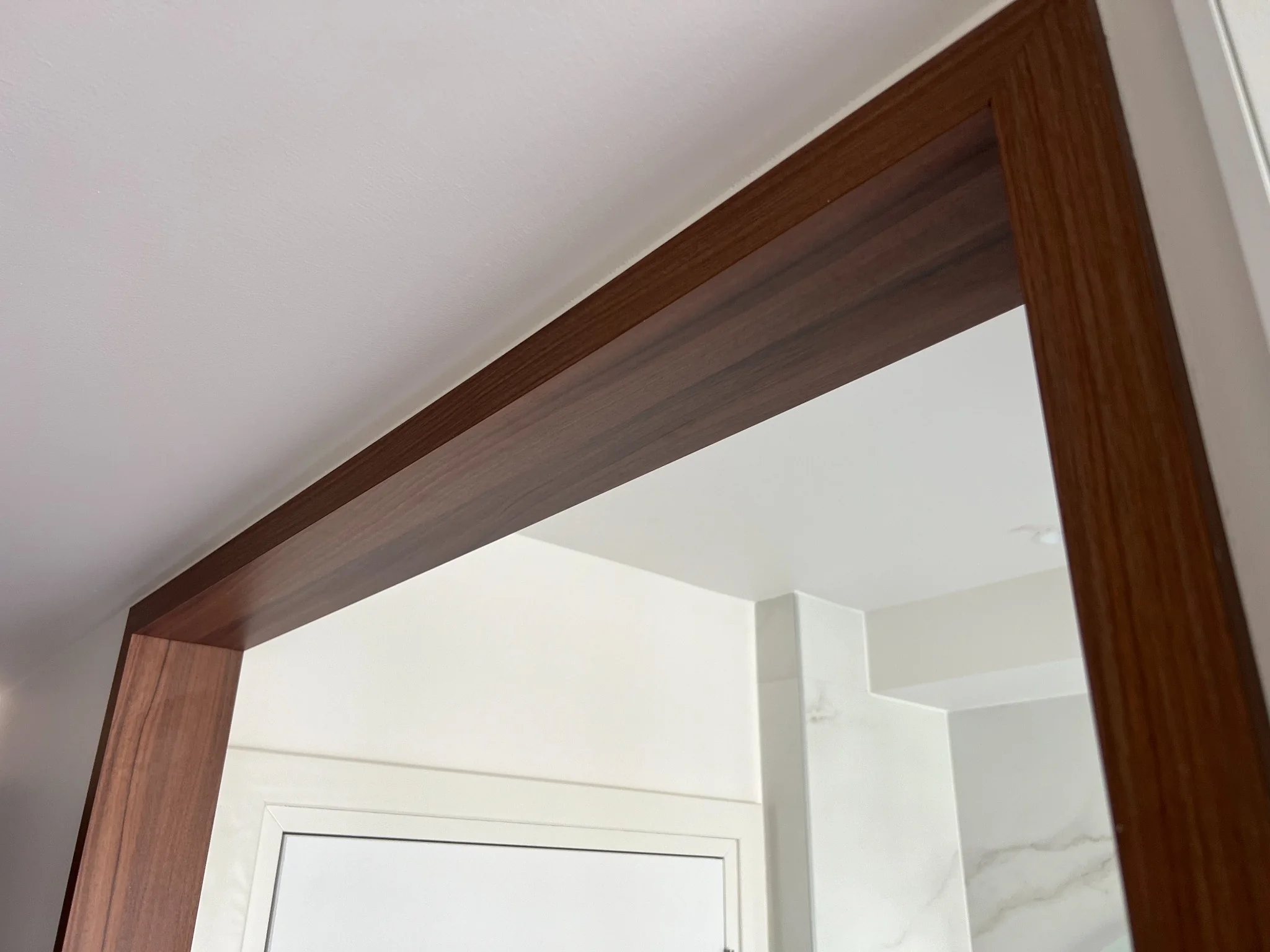 Grand encadrement bois sur mesure entre chambre et salle de bains au Royal Palace